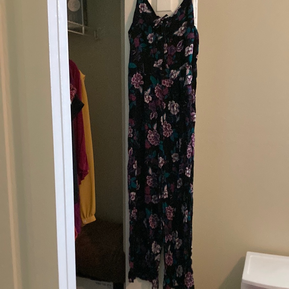 Never worn. Adjustable strap one piece jump suit